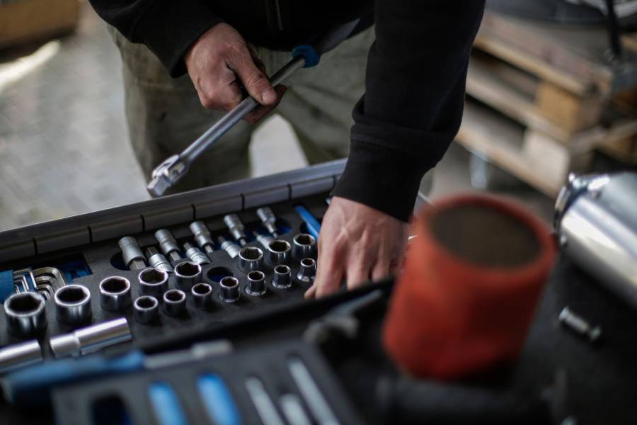 A technician choosing sockets from a tool set